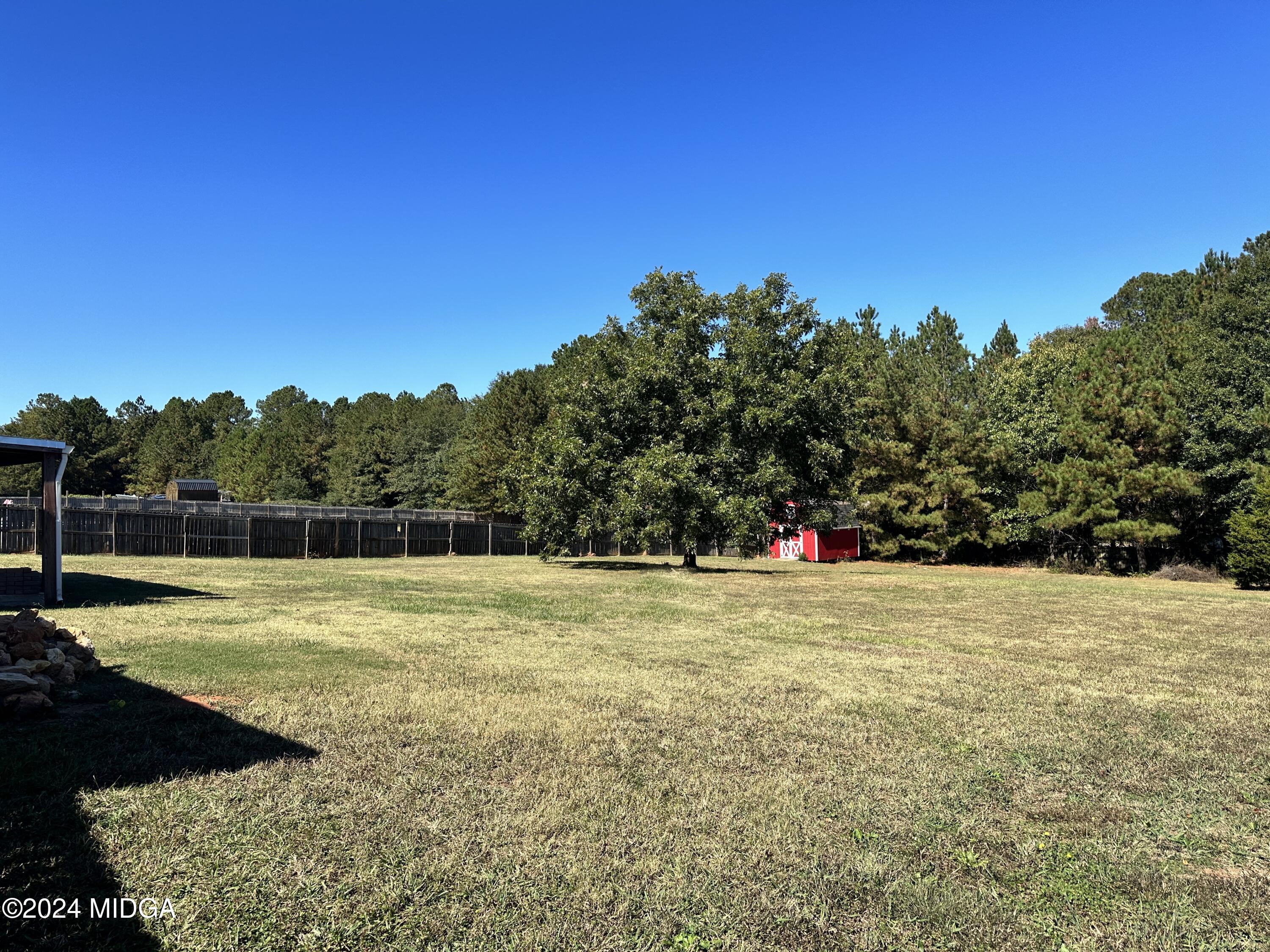 106 Meadow View Drive Jackson, GA 30233 - Photo 28 of 40 a view of a field with trees in the background