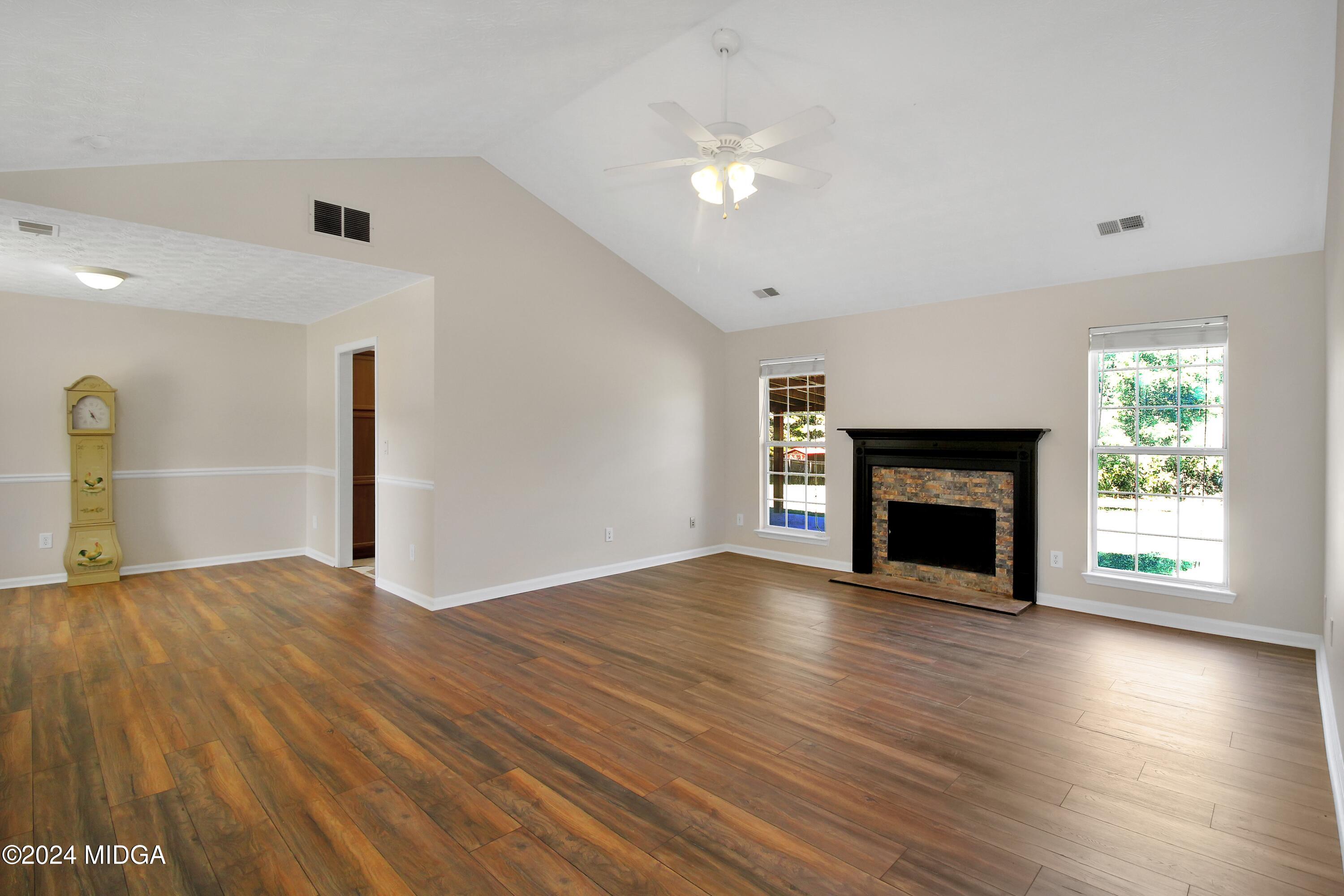 106 Meadow View Drive Jackson, GA 30233 - Photo 3 of 40 a view of empty room with wooden floor and fireplace