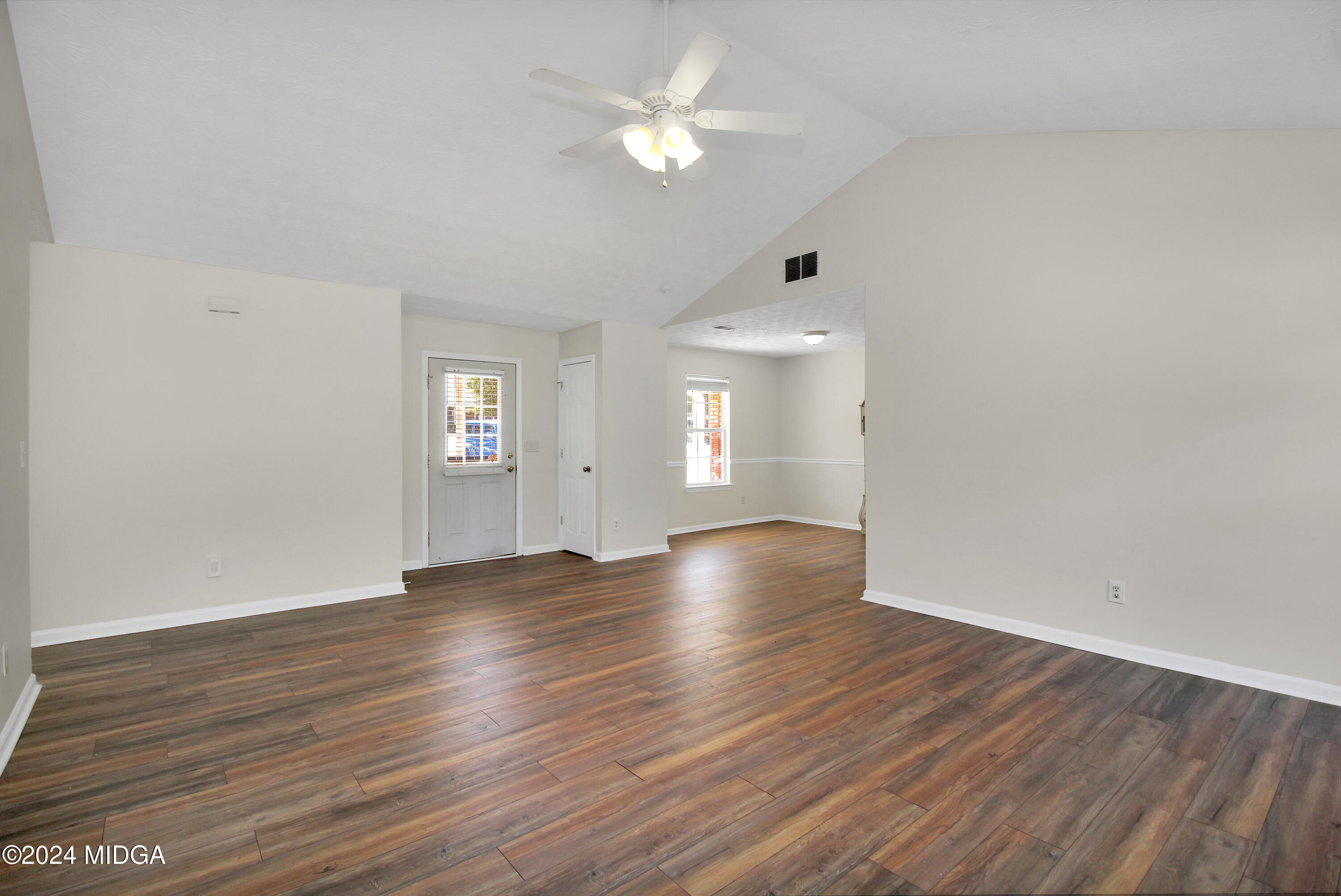 106 Meadow View Drive Jackson, GA 30233 - Photo 4 of 40 a view of an empty room with window and wooden floor