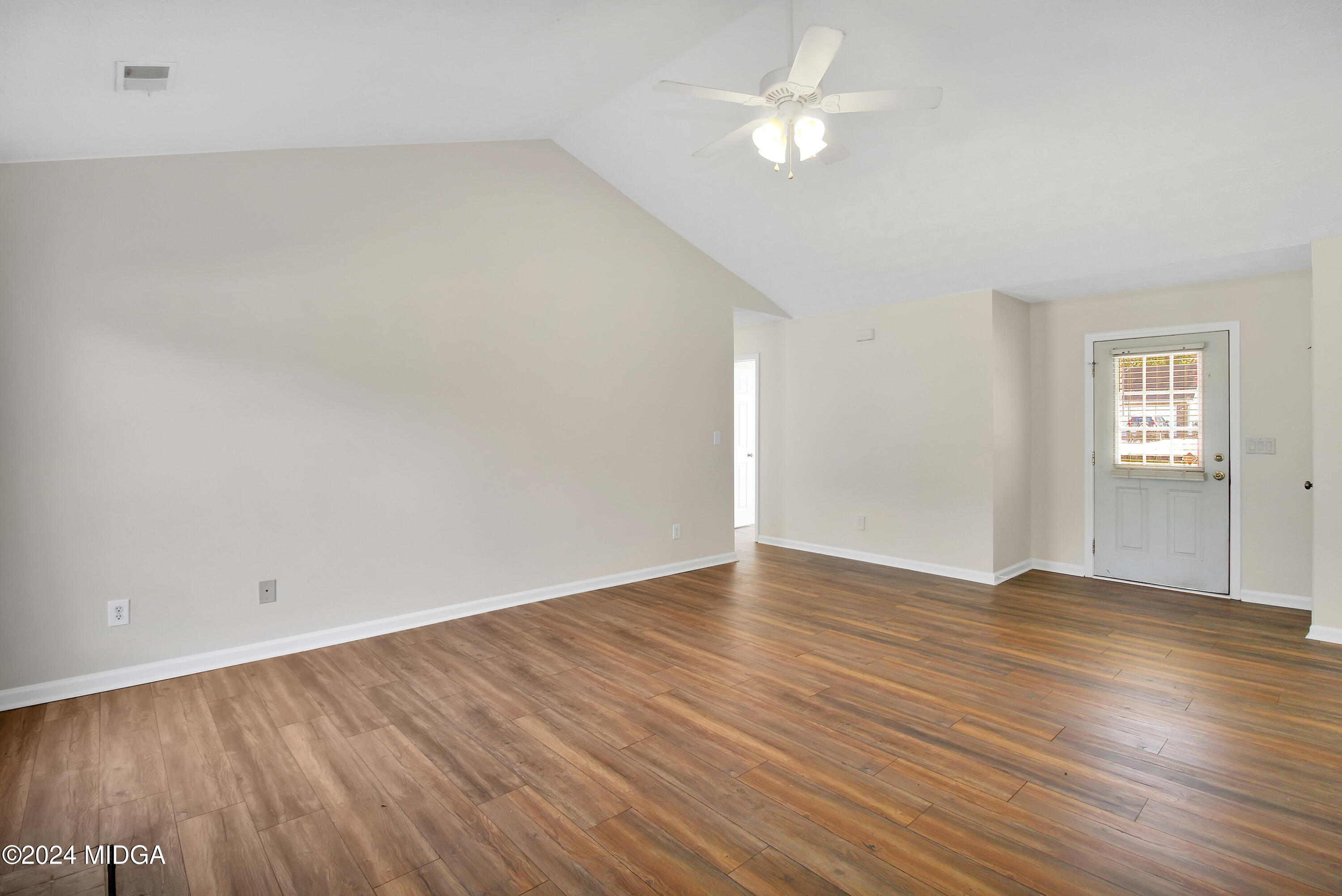 106 Meadow View Drive Jackson, GA 30233 - Photo 5 of 40 an empty room with wooden floor and windows