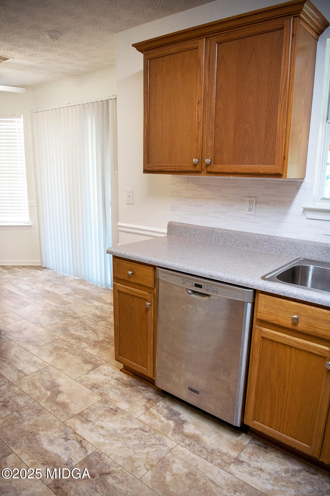 106 Meadow View Drive Jackson, GA 30233 - Photo 10 of 40 a kitchen with granite countertop cabinets a sink and dishwasher