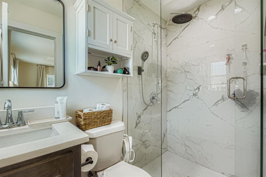 1601 Rindie Street Irving, TX 75060 - Photo 11 of 29 a bathroom with a sink toilet and shower