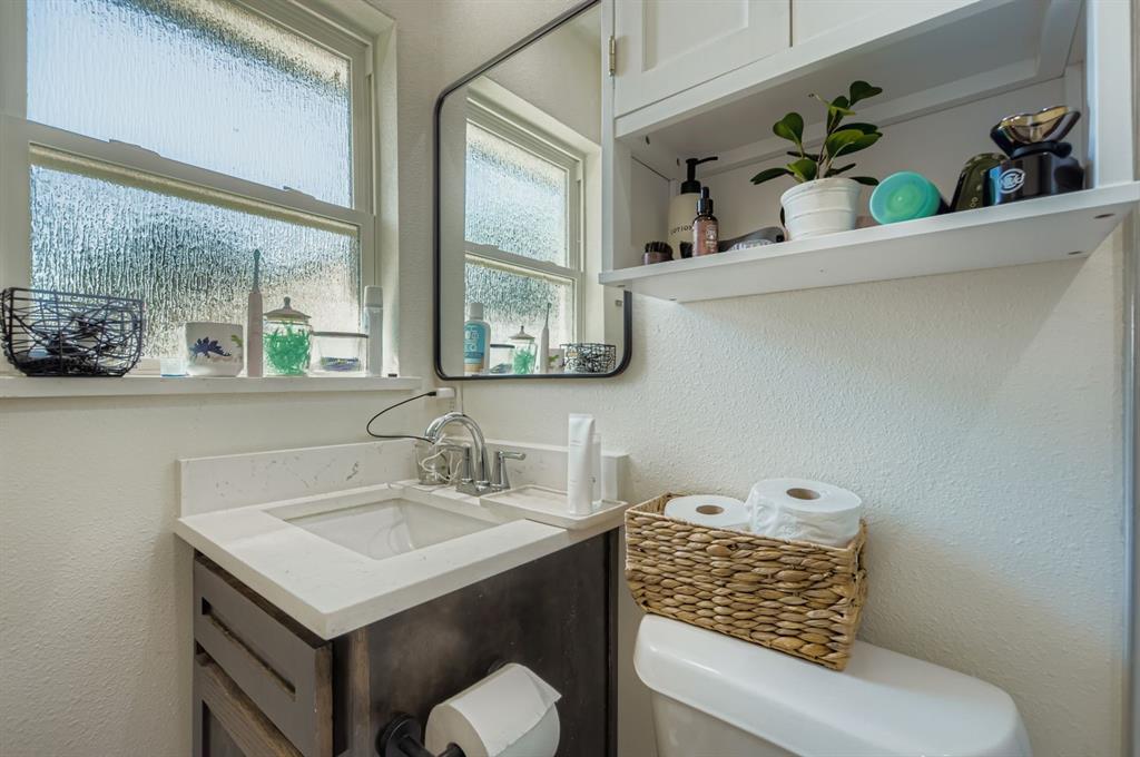 1601 Rindie Street Irving, TX 75060 - Photo 12 of 29 a bathroom with a sink and a toilet