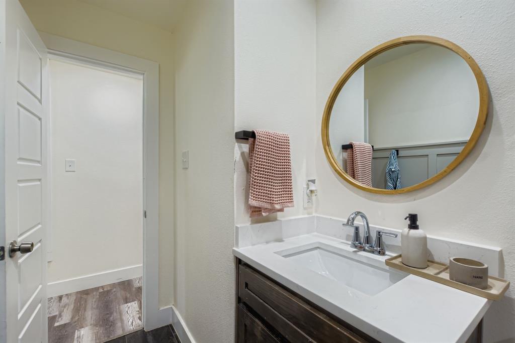1601 Rindie Street Irving, TX 75060 - Photo 16 of 29 a bathroom with a sink and a mirror