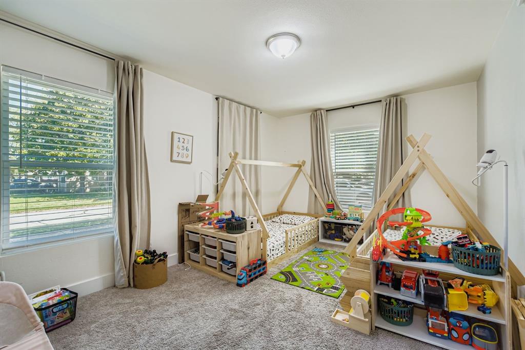 1601 Rindie Street Irving, TX 75060 - Photo 17 of 29 a bedroom with baby toys and a large window