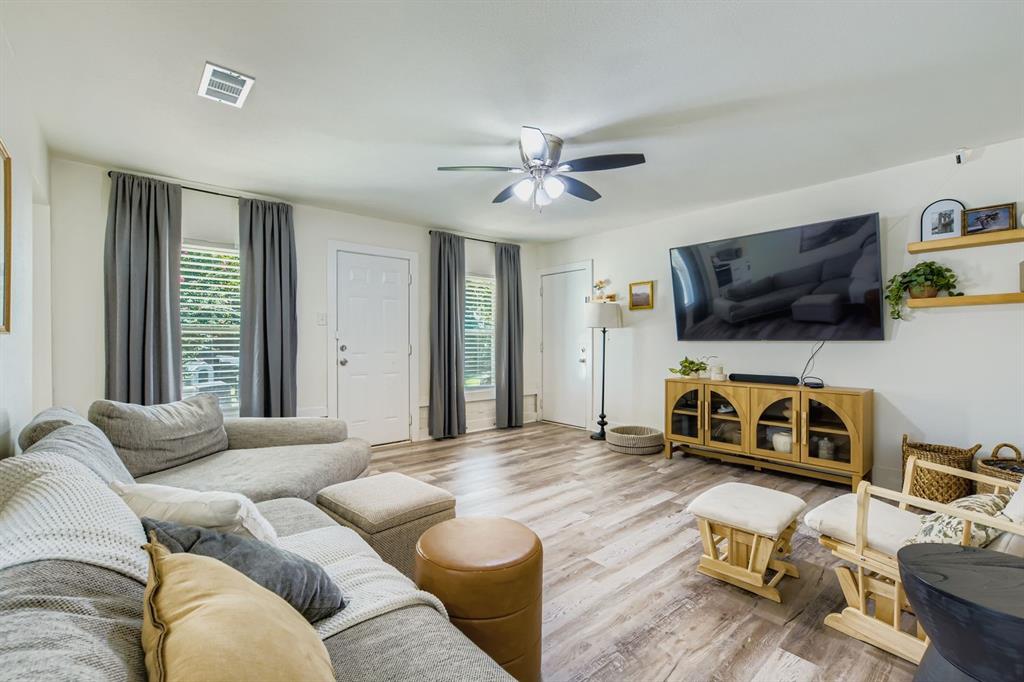 1601 Rindie Street Irving, TX 75060 - Photo 2 of 29 a bedroom with furniture and a flat screen tv