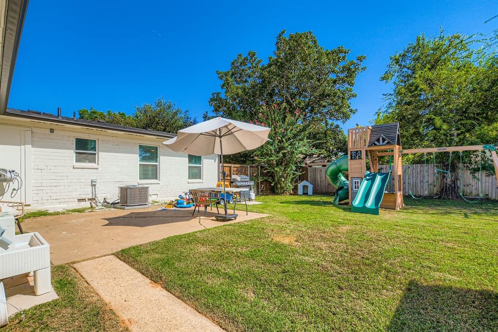 1601 Rindie Street Irving, TX 75060 - Photo 25 of 29 a view of a backyard with sitting area and slide