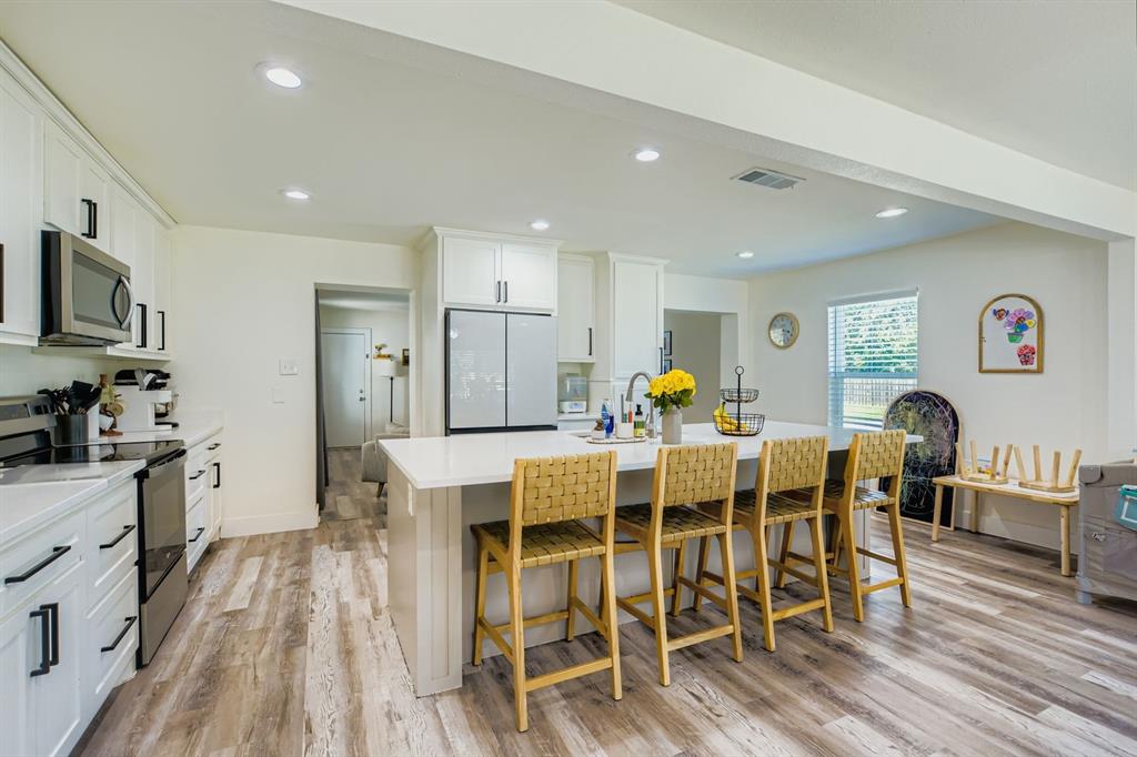 1601 Rindie Street Irving, TX 75060 - Photo 7 of 29 a view of a dining room with furniture and wooden floor