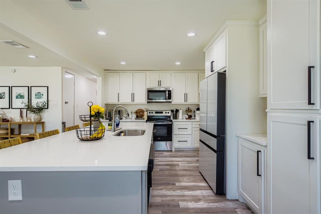 1601 Rindie Street Irving, TX 75060 - Photo 8 of 29 a kitchen with a refrigerator a stove and a sink