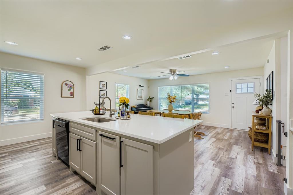 1601 Rindie Street Irving, TX 75060 - Photo 9 of 29 a view of a kitchen counter top space with sink wooden floor and a window