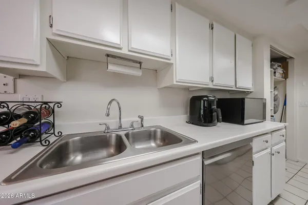 a kitchen with white cabinets and a sink