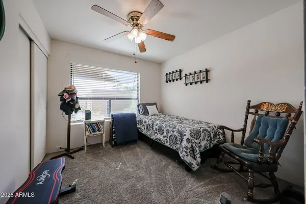 a bedroom with furniture and a window