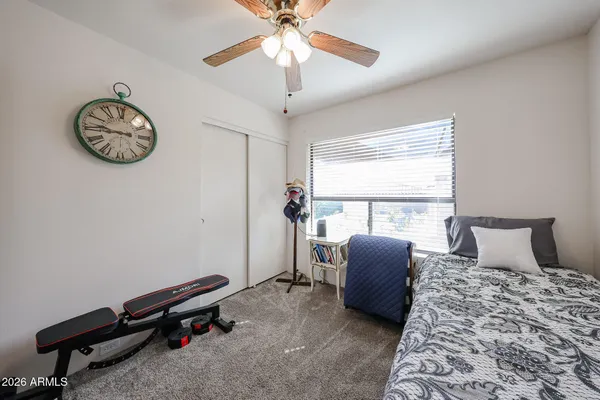 a bedroom with a large bed and a window
