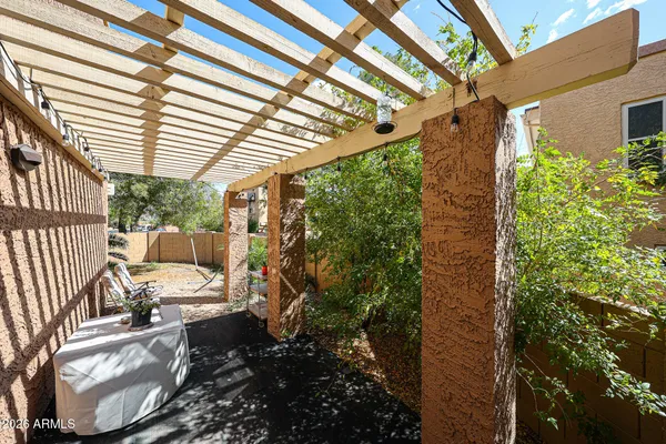 a view of a porch with furniture and a yard