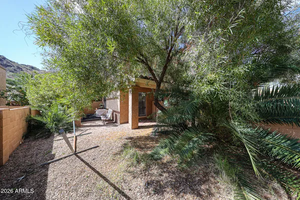 a view of a house with backyard and sitting area