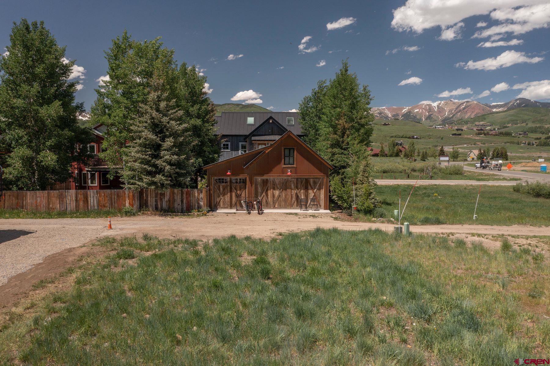 520 Teocalli Avenue Crested Butte, CO 81224 - Photo 9 of 11 a view of a house with a yard and a garden