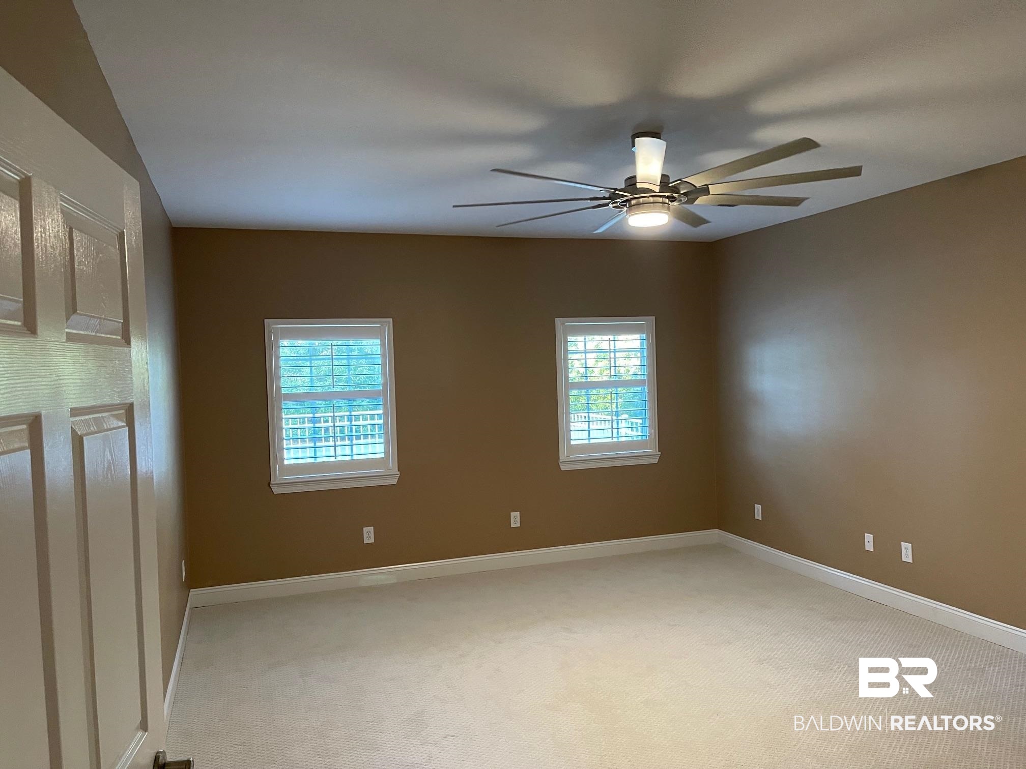 109 Savannah Circle Foley, AL 36535 - Photo 11 of 17 Unfurnished room featuring a wealth of natural light, ceiling fan, and light colored carpet