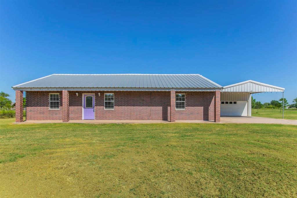 293 West Old Axtell Road Waco, TX 76705 - Photo 1 of 1 Single story home featuring a front yard, brick siding, covered porch, and a garage