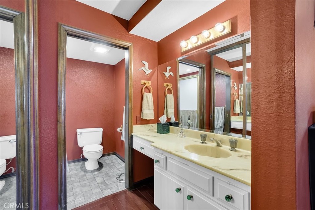 745 Main Street, Unit 107 El Segundo, CA 90245 - Photo 22 of 38 a bathroom with a sink a toilet and a large mirror