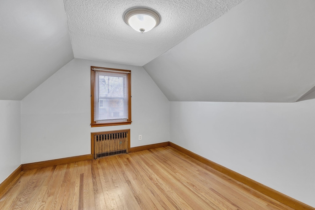 513 Springfield Street Chicopee, MA 01013 - Photo 20 of 38 an empty room with wooden floor and windows