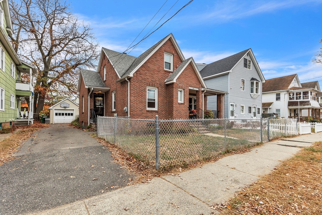 513 Springfield Street Chicopee, MA 01013 - Photo 3 of 38 a front view of a house with a yard