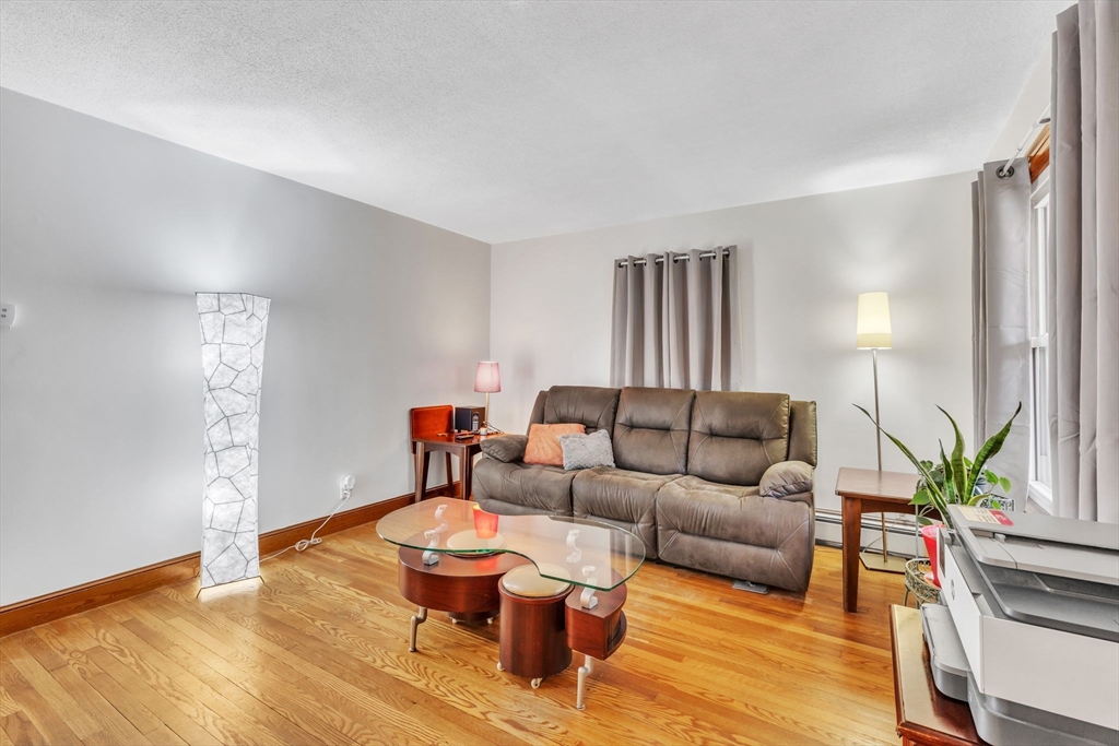 513 Springfield Street Chicopee, MA 01013 - Photo 8 of 38 a living room with furniture and a wooden floor