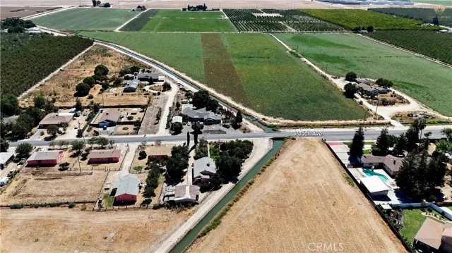 an aerial view of a house a yard and mountain view in back yard