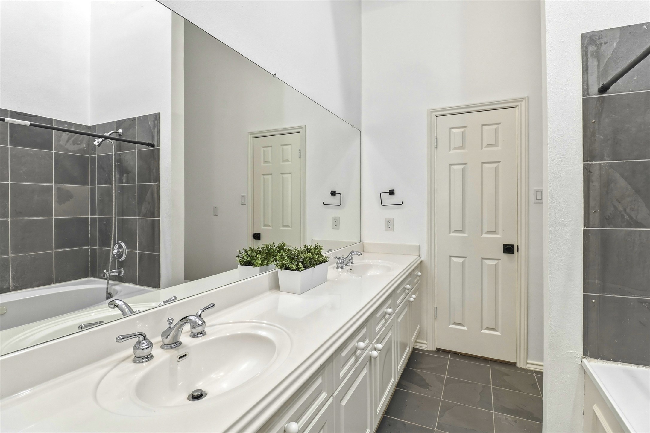 2918 Ranch Road 620, Unit 265 Austin, TX 78734 - Photo 18 of 40 Double vanity and bath with sleek, contrasting grey tile walls.
