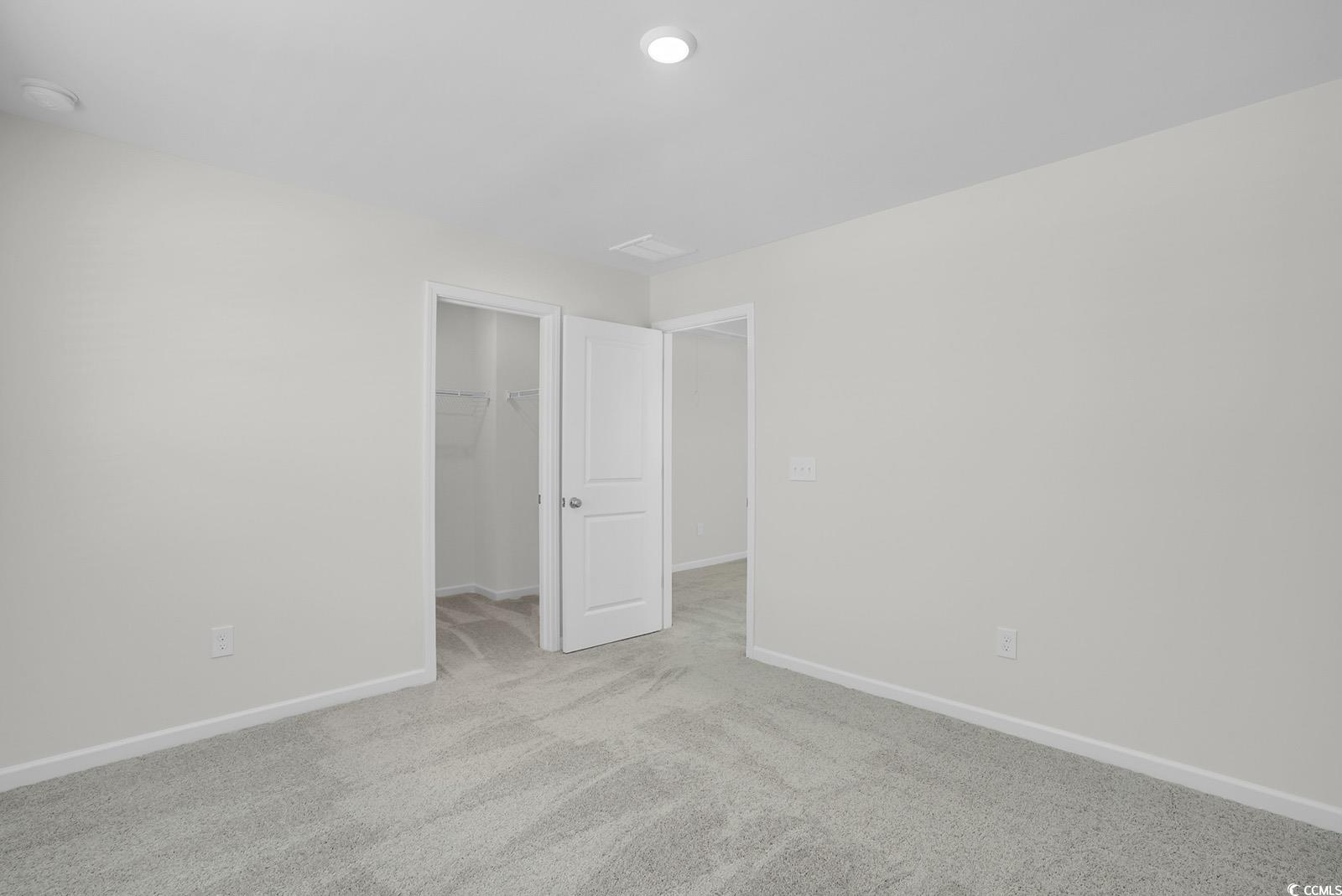 1113 Hainer Place Drive Conway, SC 29526 - Photo 22 of 28 Unfurnished bedroom with a walk in closet and carpet floors