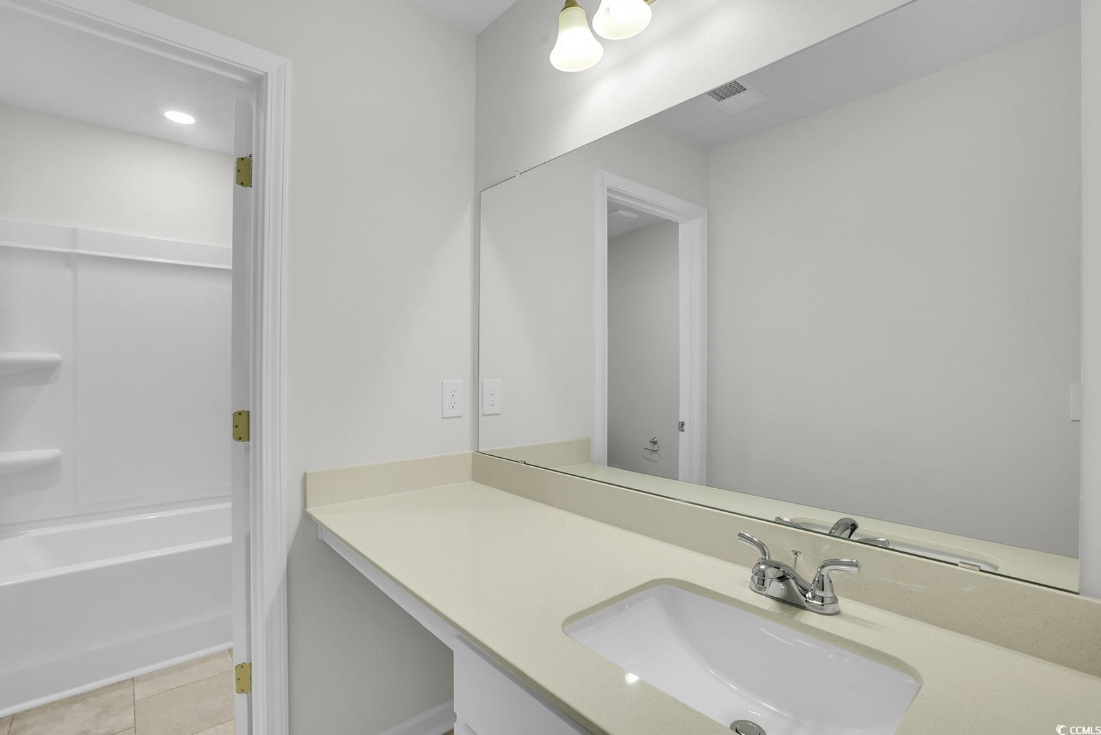 1113 Hainer Place Drive Conway, SC 29526 - Photo 23 of 28 Full bath with vanity, light tile patterned floors, and shower / bath combination