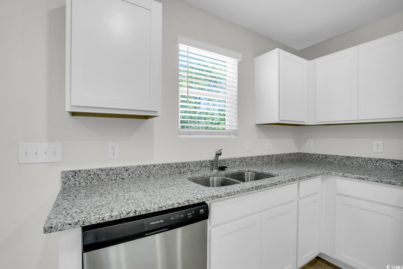 1113 Hainer Place Drive Conway, SC 29526 - Photo 4 of 28 Kitchen featuring light stone counters, dishwasher, and white cabinetry