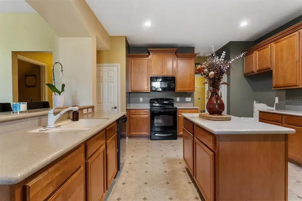 a kitchen with stainless steel appliances a sink stove refrigerator and cabinets