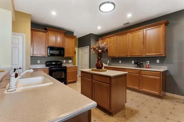a view of living room with kitchen island furniture and a sink