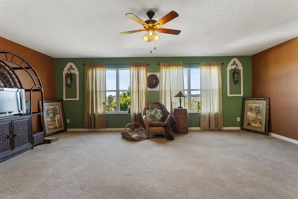 a view of a livingroom with furniture and a ceiling fan