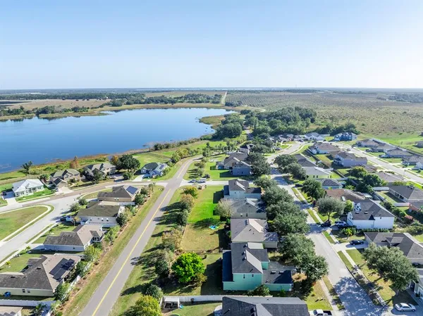an aerial view of residential building and lake