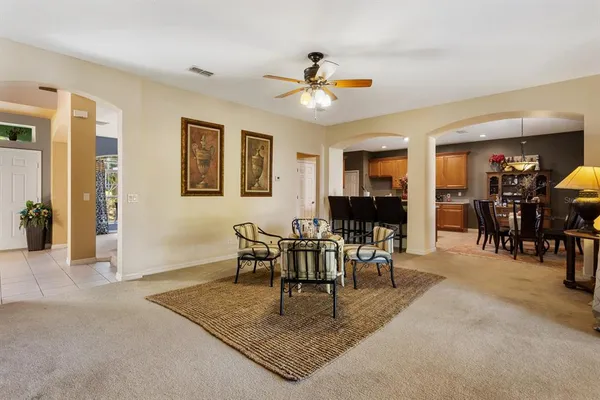 a living room with furniture and large windows