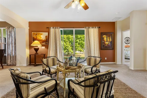 a view of a dining room with furniture and a chandelier