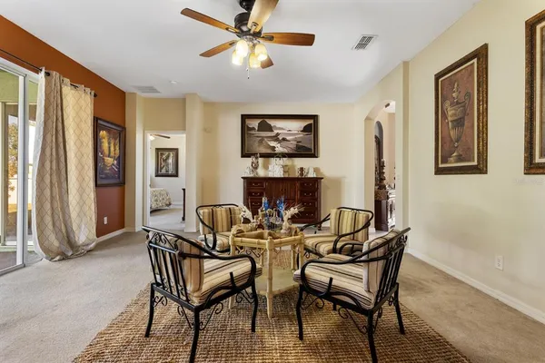 a dining room with furniture and a floor to ceiling window