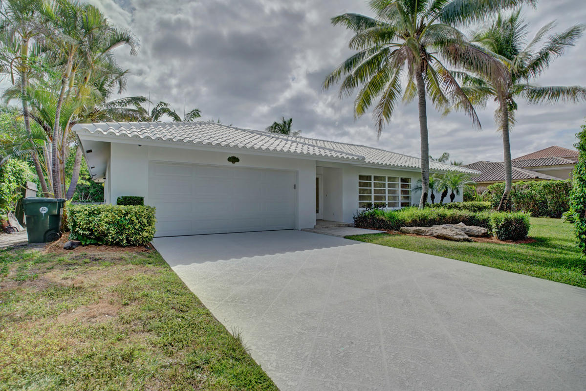 5600 Nassau Drive Boca Raton, FL 33487 - Photo 1 of 21 a view of a house with a yard and potted plants