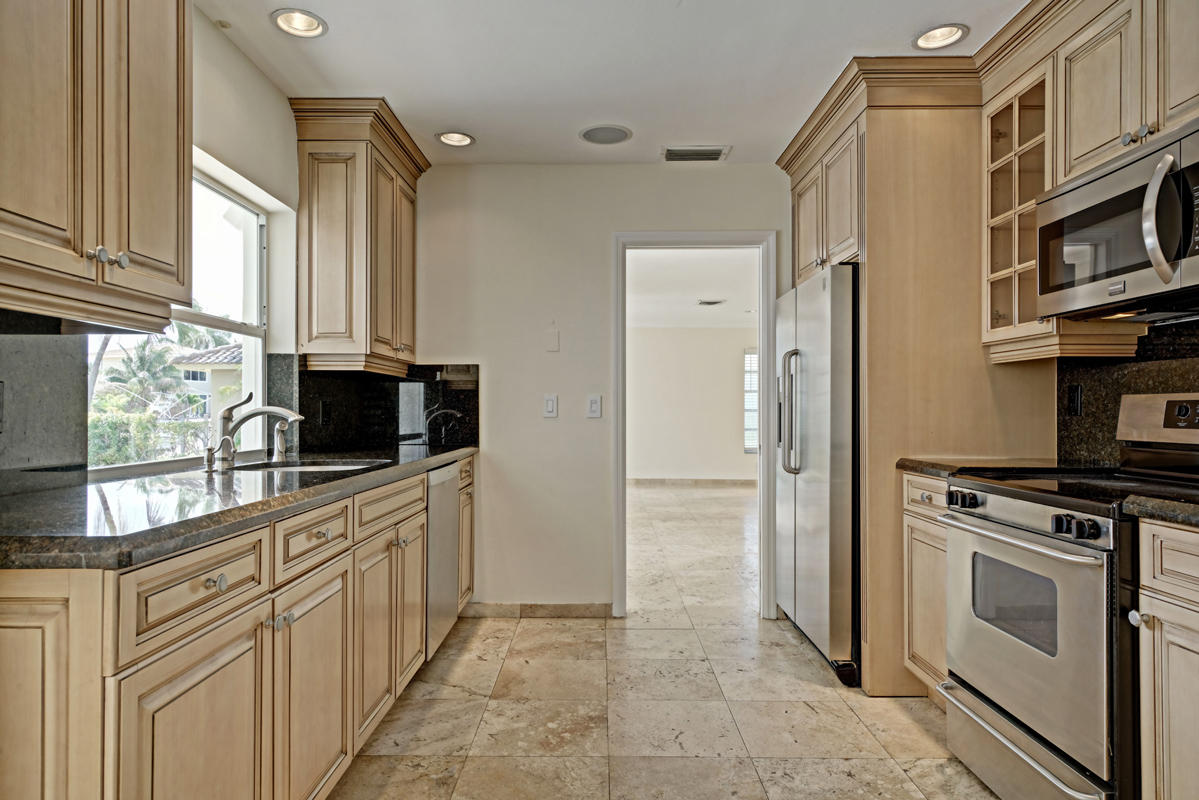 5600 Nassau Drive Boca Raton, FL 33487 - Photo 11 of 21 a kitchen with stainless steel appliances a stove a sink and a microwave