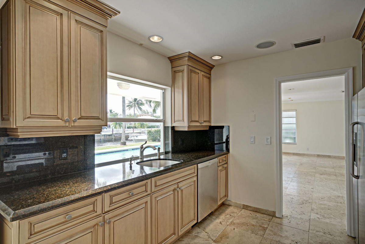 5600 Nassau Drive Boca Raton, FL 33487 - Photo 12 of 21 a kitchen with stainless steel appliances granite countertop a sink a stove and a refrigerator
