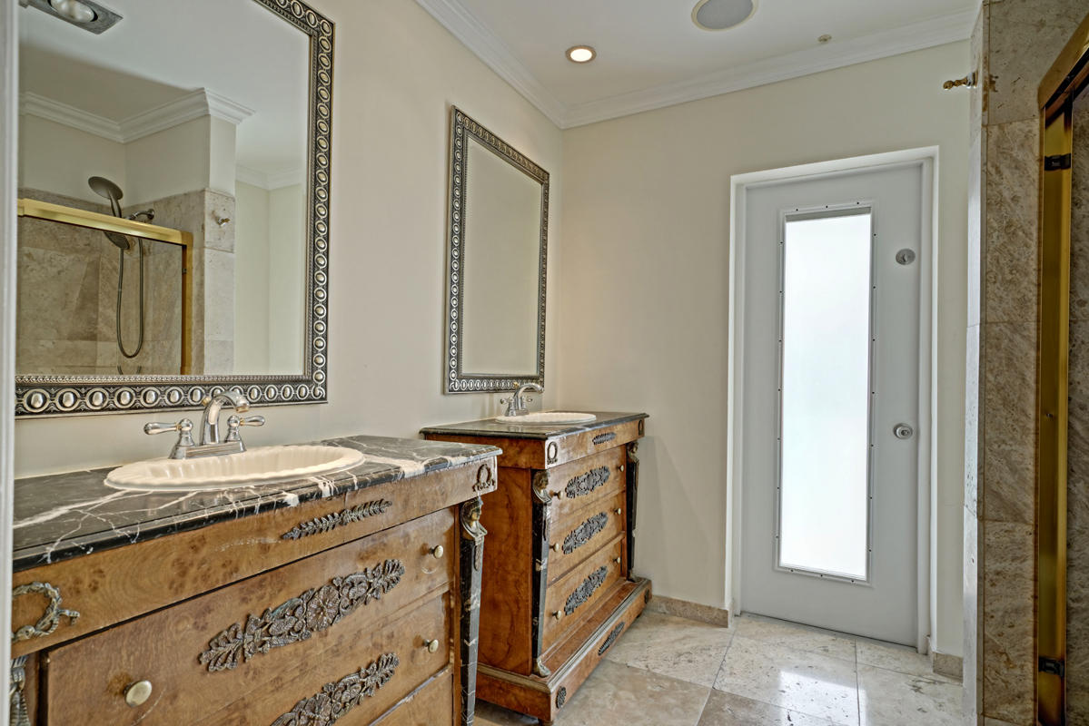 5600 Nassau Drive Boca Raton, FL 33487 - Photo 16 of 21 a bathroom with a sink and a mirror