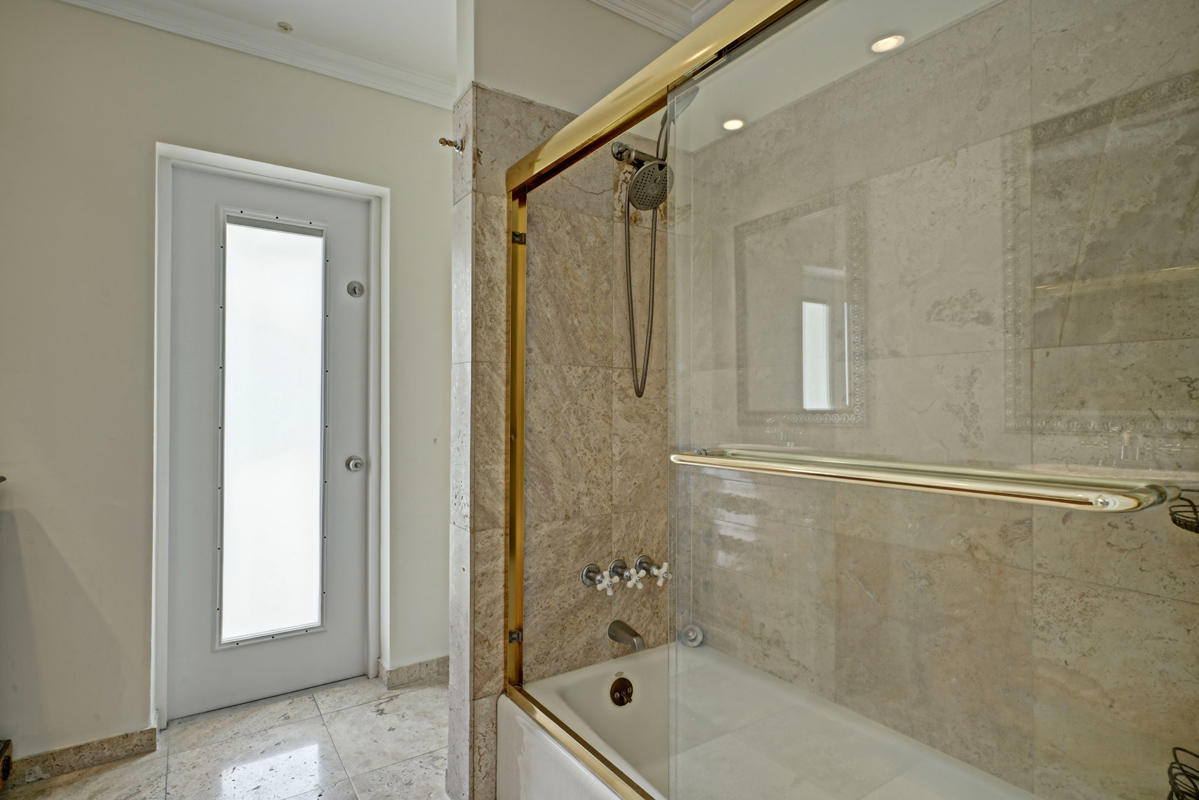 5600 Nassau Drive Boca Raton, FL 33487 - Photo 17 of 21 a bathroom with a tub shower and mirror