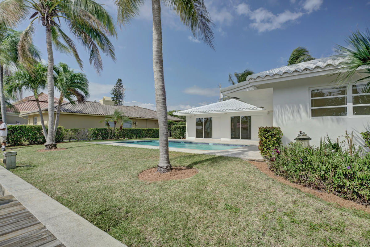 5600 Nassau Drive Boca Raton, FL 33487 - Photo 2 of 21 a view of a house with a backyard and a tree