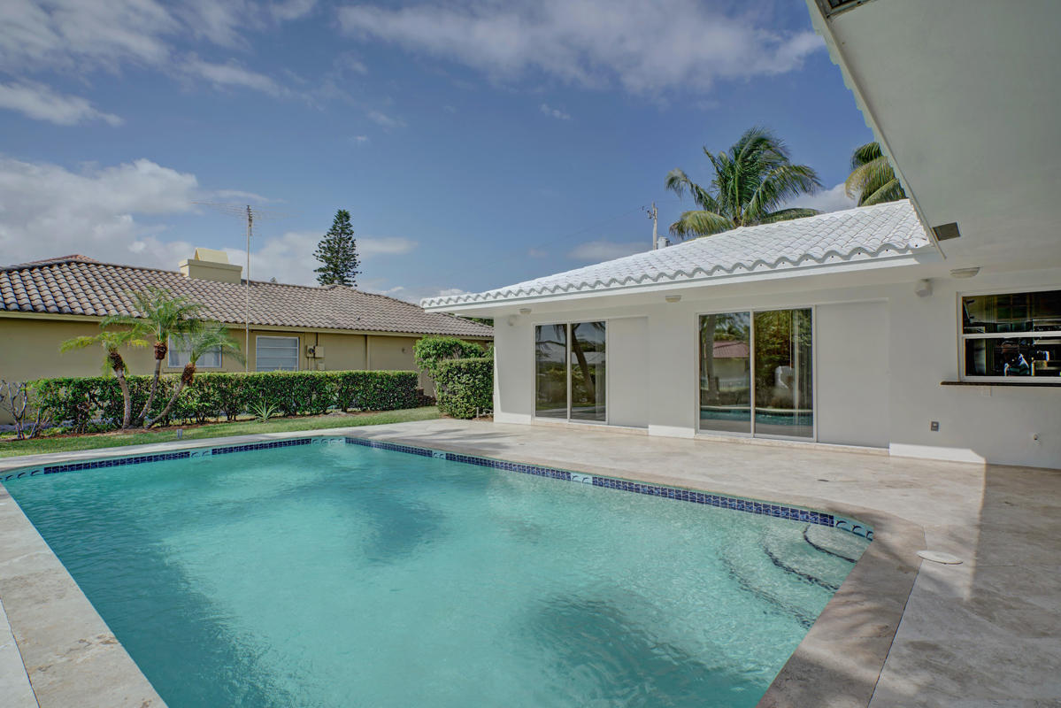 5600 Nassau Drive Boca Raton, FL 33487 - Photo 3 of 21 a front view of a house with a garden and porch