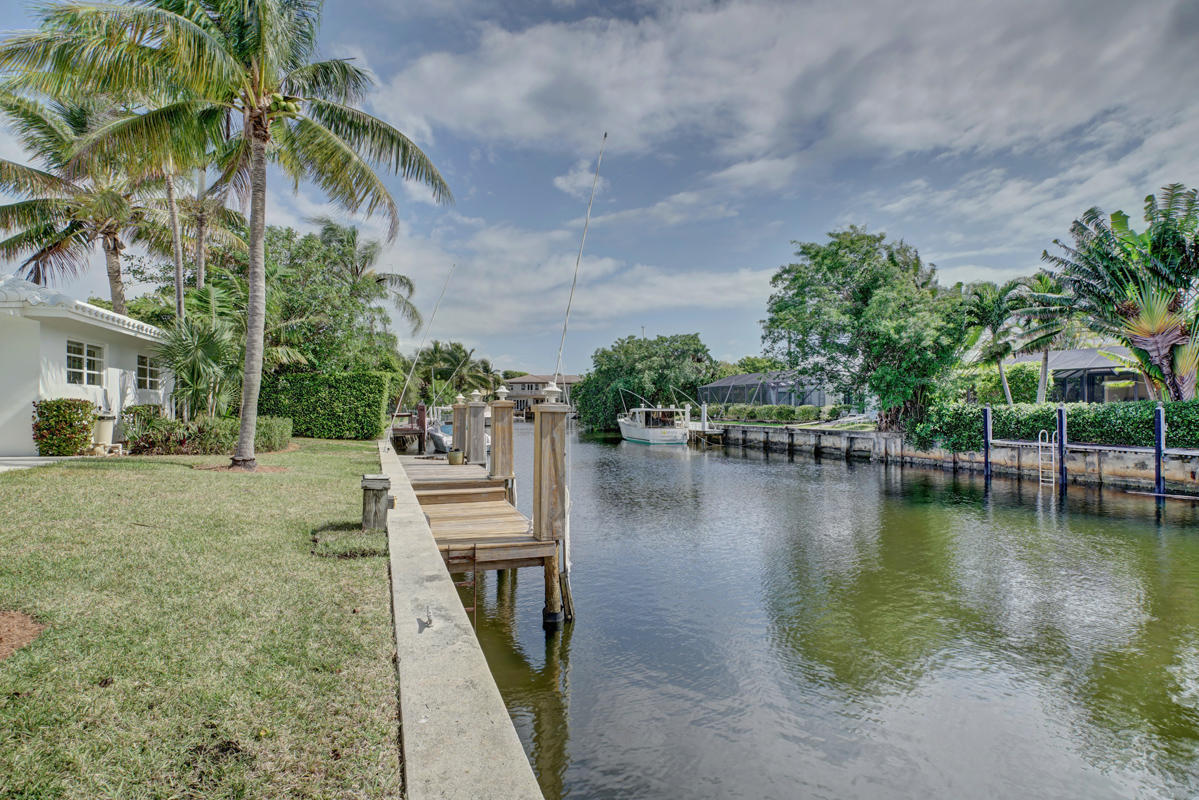 5600 Nassau Drive Boca Raton, FL 33487 - Photo 4 of 21 a view of a lake with a house in the background