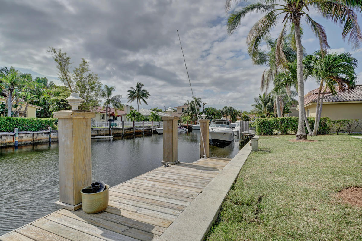 5600 Nassau Drive Boca Raton, FL 33487 - Photo 5 of 21 a view of a lake with boats and palm trees