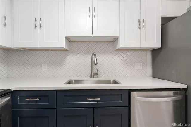 a kitchen with stainless steel appliances a refrigerator and cabinets