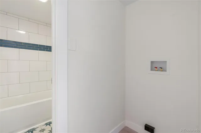 a bathroom with a toilet and bathtub