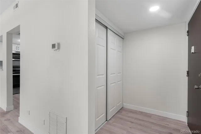 a view of hallway with closet area